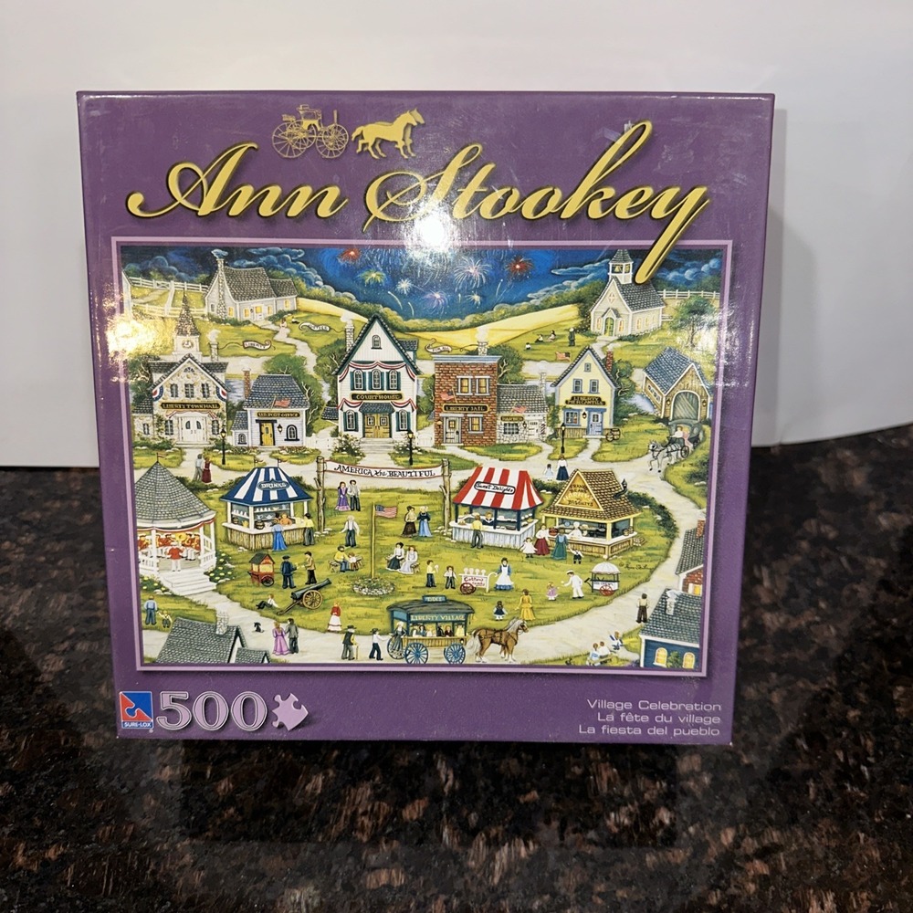 Ann Stookey: Village Celebration 500pc Sure-Lox 19x14" Puzzle America Beautiful